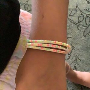 Preloved bracelet with colored gems on it.